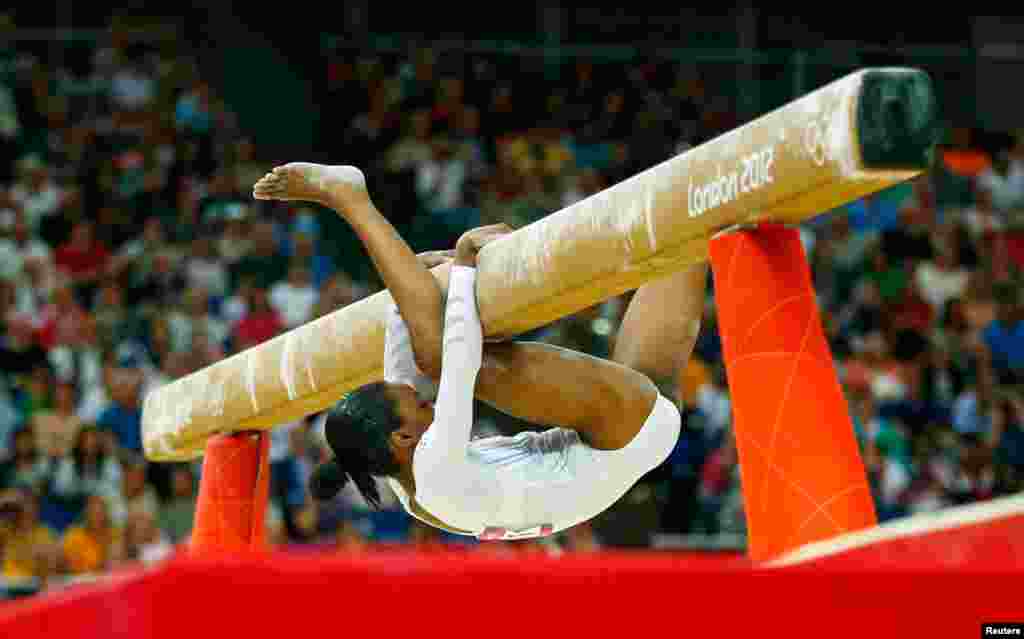 Gabrielle Douglas of the U.S. falls during the women's gymnastics balance beam final.