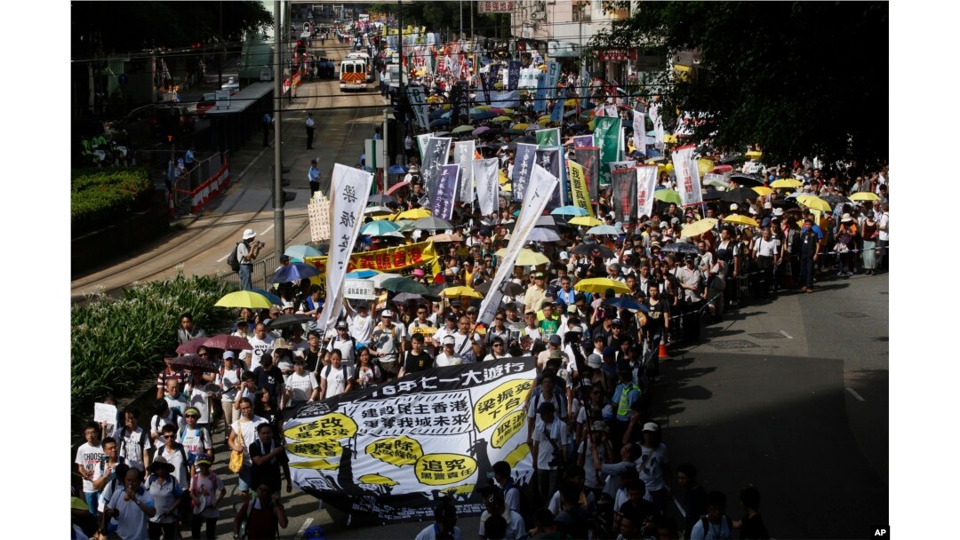 FILE - Pro-democracy protesters march during an annual protest marking Hong Kong's handover from British to Chinese rule in 1997 in Hong Kong, Wednesday, July 1, 2015. In 2014, millions of pro-democracy protesters blocked Hong Kong’s streets for several weeks.