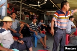 Villagers gather to discuss the recent arrest of their democratically elected village chief Lin Zulian, in the southern Chinese fishing village of Wukan, June 20, 2016.