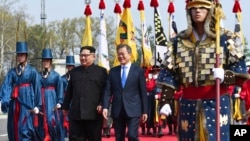North Korean leader Kim Jong Un, left, and South Korean President Moon Jae-in walk together at the border village of Panmunjom in the Demilitarized Zone, April 27, 2018. Kim made history Friday by crossing over the world's most heavily armed border to greet his rival, Moon, for talks on North Korea's nuclear weapons.