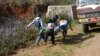 In this Feb. 17, 2015, photo provided by the Eleven Media Group, Myanmar red-cross members carry an injured victim during a clash between government troops and Kokang rebels in Kokang, northeastern Shan State, more than 800 kilometers (500 miles) northeast of Yangon, Myanmar. 