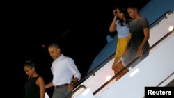 U.S. President Barack Obama, first lady Michelle Obama and their daughters Sasha (left) and Malia (2nd right) arrive Dec. 19, 2015, via Air Force One at Joint Base Pearl Harbor-Hickam in Honolulu, Hawaii. 