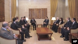 Syria's President Bashar al-Assad (center R) meets U.N.-Arab League envoy Kofi Annan (center L) in Damascus March 10, 2012.