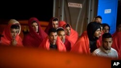 In this photo taken Oct. 27, 2018, migrants arrive at the port of San Roque, southern Spain, after being rescued by Spain's Maritime Rescue Service in the Strait of Gibraltar. 