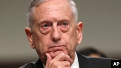 FILE - Defense Secretary Jim Mattis listens while testifying on Capitol Hill in Washington, June 13, 2017, before a Senate Armed Services Committee hearing on the defense department's budget. 