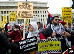 People protest outside of the Washington Convention Center where the 2017 AIPAC Policy Conference is taking place in Washington, March 26, 2017.