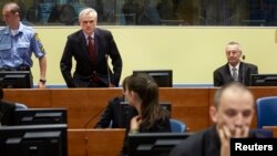 Franko Simatovic (top R), former commander of the Special Operations Unit of the Serbian State Security Service, and Jovica Stanisic (top C), former chief of Serbian State Security, sit in court prior to the Trial Chamber Judgement at the International Cr