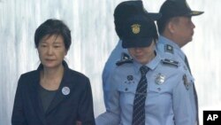 FILE - In this Oct. 10, 2017, photo, former South Korean President Park Geun-hye, left, arrives to attend a hearing on the extension of her detention at the Seoul Central District Court in Seoul, South Korea.