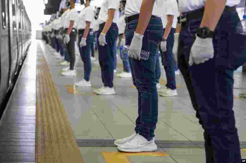 Police trainees join in an exercise for correct social distancing at the LRT-2 train station in Manila, Philippines, in preparation for the possible return of public transportation as coronavirus-related restrictions may ease next week. &nbsp;