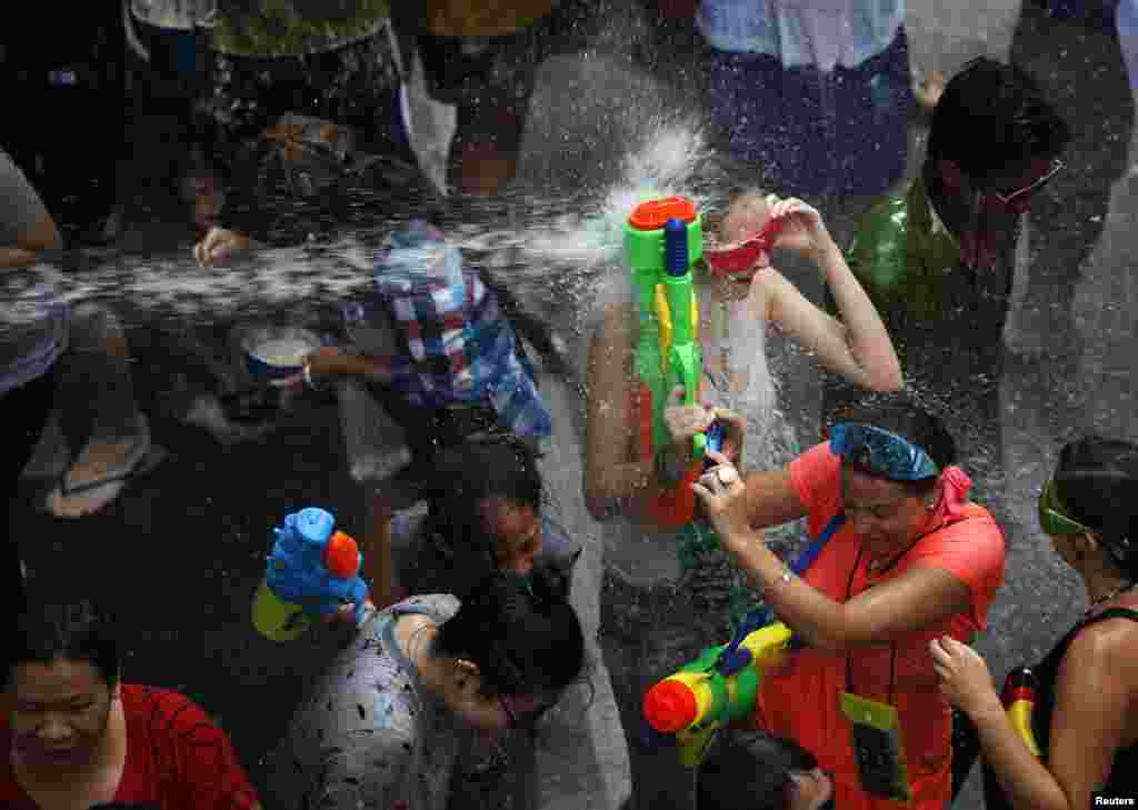 Revellers take part in a water fight during Songkran Festival celebrations on Silom Road in Bangkok, Thialand.