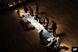 Voters pick up ballots before voting in Lyon, France, May 26, 2019.