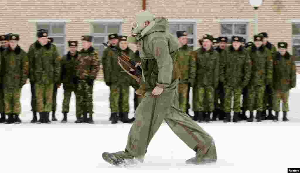 Servicemen of the Belarussian Interior Ministry take part in a competition at their base near the village of Okolitsa, some 30 km (19 miles) east of Minsk, to mark the Defender of the Fatherland Day. 