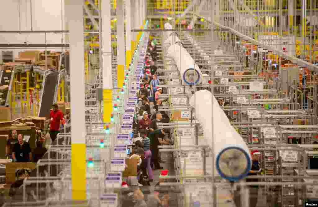 Workers prepare outgoing shipments at an Amazon Fulfillment Center before the Christmas rush in Tracy, California.