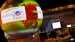 A giant globe displays a video animation during a conference about Antarctic mass change at the U.S. Pavillon during the COP21, United Nations Climate Change Conference, in Le Bourget, outside Paris, Tuesday, Dec. 1, 2015.
