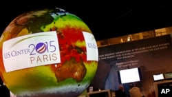 A giant globe displays a video animation during a conference about Antarctic mass change at the U.S. Pavillon during the COP21, United Nations Climate Change Conference, in Le Bourget, outside Paris, Tuesday, Dec. 1, 2015. (AP Photo/Francois Mori)