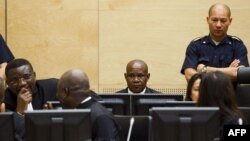 FILE - Congolese ex-militia boss Mathieu Ngudjolo (C) waits for the verdict on his trial at the International Criminal Court in The Hague, December 18, 2012.
