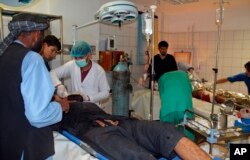 Afghans are treated at a hospital following an airstrike in the Char Dara district of Kunduz province, April 2, 2018.