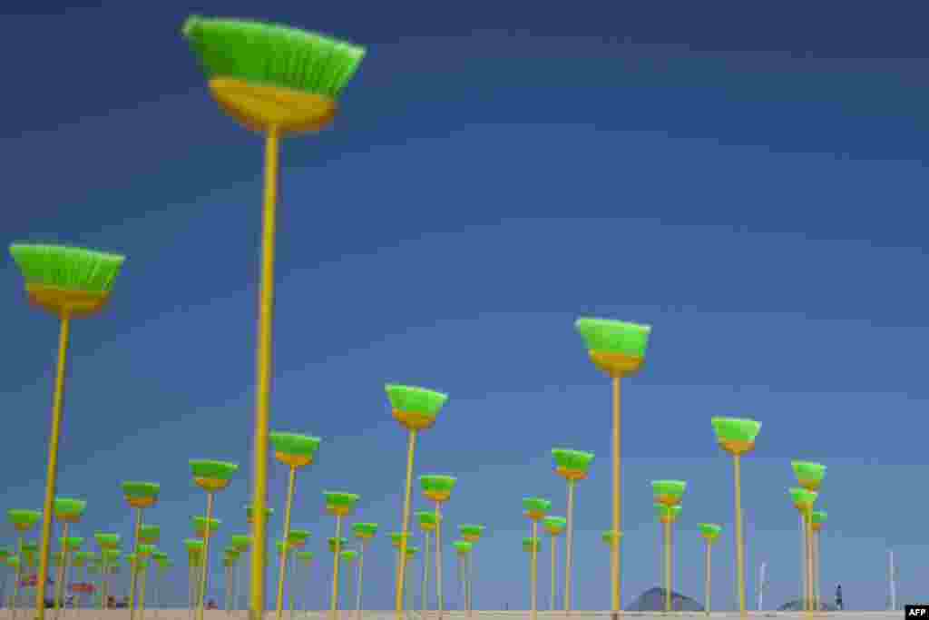 Brooms stand after being set on the sand during a protest against corruption at Copacabana beach in Rio de Janeiro, Brazil, Monday Sept. 19, 2011. (AP Photo/Felipe Dana)