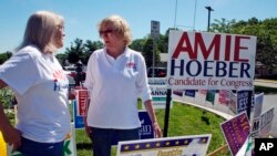 Amie Hoeber, right, a Republican who is running in the Maryland 6th Congressional District primary, talks to a supporter at an early voting center in Frederick, Md., June 14, 2018.