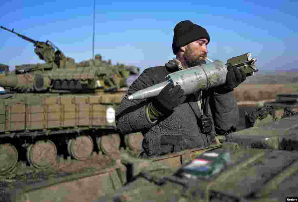 A Ukrainian serviceman loads ammunition into a tank in the territory controlled by Ukraine's government forces, in the Donetsk region, Feb. 13, 2015.