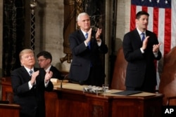 President Donald Trump, Vice President Mike Pence and House Speaker Paul Ryan applaud Carryn Owens, widow of Navy SEAL William “Ryan” Owens, on Capitol Hill in Washington, Feb. 28, 2017, during the president's address before a joint session of Congress.