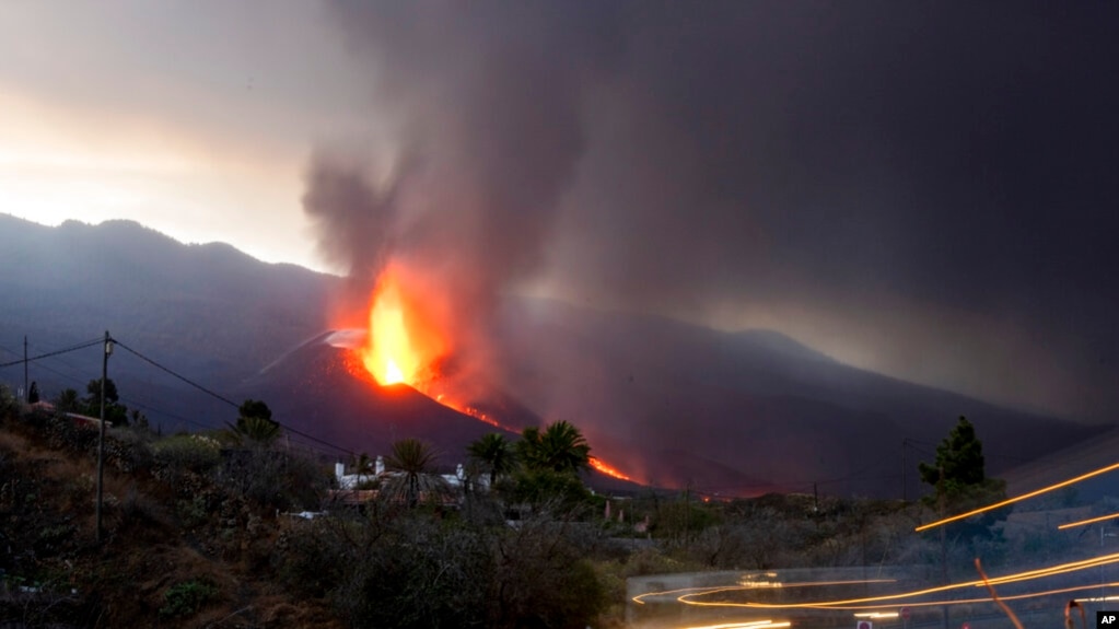 FILE - Lava flows from the Cumbre Vieja volcano as it continues to erupt on the Canary island of La Palma, Spain, Oct. 27, 2021.