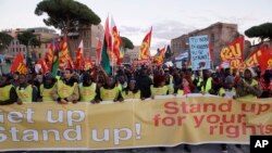 Demonstrators in Rome shout “Get Up! Stand Up! Stand Up for your rights!” against racism and the government's immigration policies and the so-called “Salvini decree”, that aims to reduce the number of migrants granted humanitarian protection.