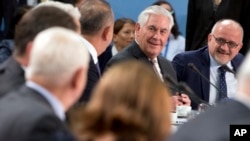 U.S. Secretary of State Rex Tillerson (rear second right) speaks with Turkish Foreign Minister Mevlut Cavusoglu (rear third right) during a meeting of the North Atlantic Council at NATO headquarters in Brussels, March 31, 2017.
