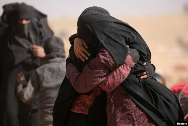 Women hug near the village of Baghuz, Deir el-Zour province, in Syria, March 7, 2019.