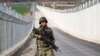 FILE - A Turkish soldier patrols along a wall on the border line between Turkey and Syria near the southeastern city of Kilis, Turkey, March 2, 2017.