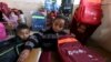 Syrian children unpack their backpacks — donated by UNICEF — inside a classroom in Ras al-Ain city, Syria, Feb. 1, 2016.