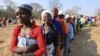 FILE: Women queue for food assistance distributed by the United Nations World Food Programme in Mwenezi, about 450 kilometers (280 miles) south of Harare, Zimbabwe, Wednesday, Sept. 9 2015.