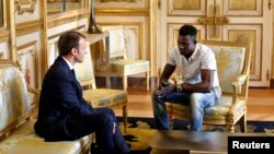 French President Emmanuel Macron meets with Mamoudou Gassama, 22, from Mali, at the Elysee Palace in Paris, May 28, 2018.