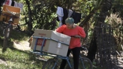 Iris Franco is seen at her home in El Ranchador, Santa Ana, El Salvador, Friday, March 5, 2021. Franco runs a bakery at home and delivers the bread on a bike.