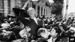 FILE - Prime Minister Mohammed Mosaddegh rides on the shoulders of cheering crowds in Tehran's Majlis Square, outside the parliament building, after reiterating his oil nationalization views to his supporters. Once expunged from its official history, documents outlining the U.S.-backed 1953 coup in Iran have been quietly published by the State Department.