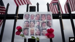 In this Nov. 18, 2016, photo, a faded photo collage shows images of the 14 victims who were killed in the Dec. 2, 2015, San Bernardino attack.