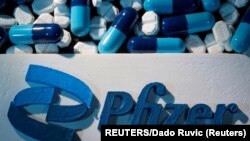 FILE - A Pfizer logo is placed near medicines from the same manufacturer in this illustration taken September 29, 2021. (REUTERS/Dado Ruvic/Illustration/File Photo)