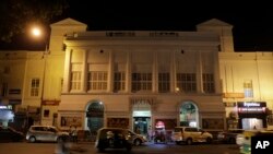 Motorists drive past the colonial era Regal Theater in New Delhi, India, March 30, 2017.