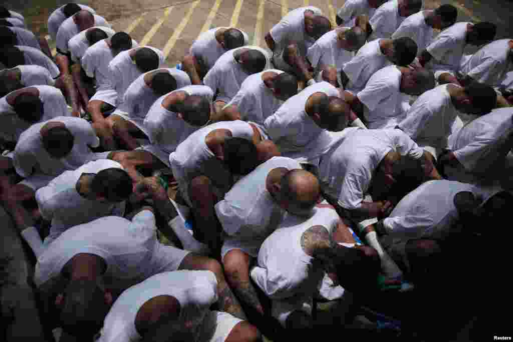 Mara Salvatrucha (MS-13) gang members wait to be escorted upon arrival at the maximum-security jail in Zacatecoluca, El Salvador, Aug. 9, 2017.