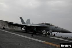 F-18 fighter jet prepares to take off from the USS Harry S. Truman aircraft carrier in the eastern Mediterranean Sea, May 4, 2018.