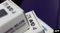 FILE - Boxes holding cellphones manufactured by ZTE are seen in a store in Miami, Fla., May 14, 2018.