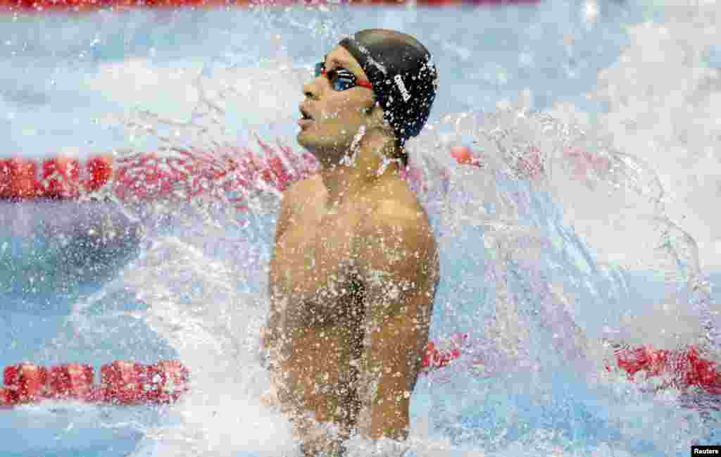 Japan's Ryosuke Irie jumps into the water to start his men's 100m backstroke heat during the London 2012 Olympic Games at the Aquatics Centre July 29, 2012.