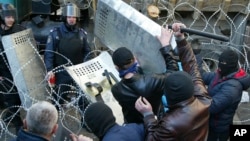 People clash with police at the regional administration building in Donetsk, Ukraine, April 6, 2014.