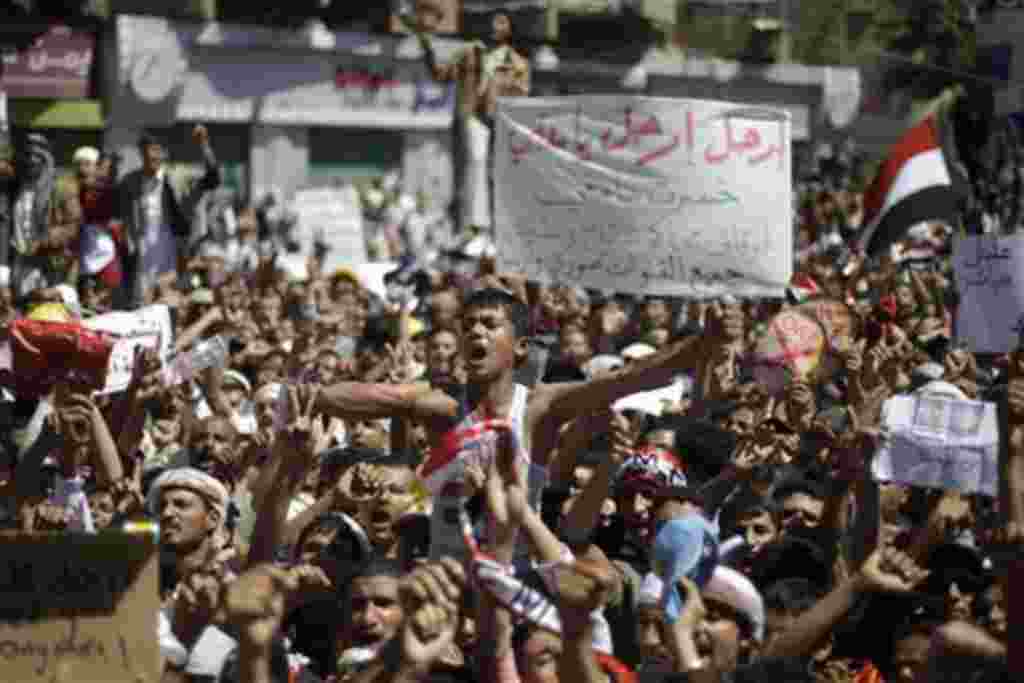 An anti-government protestor, center, reacts during a demonstration demanding the resignation of Yemeni President Ali Abdullah Saleh, in Sanaa, Yemen, Friday, Feb. 25, 2011. Tens of thousands of people gathered in a main square in the Yemeni capital for F