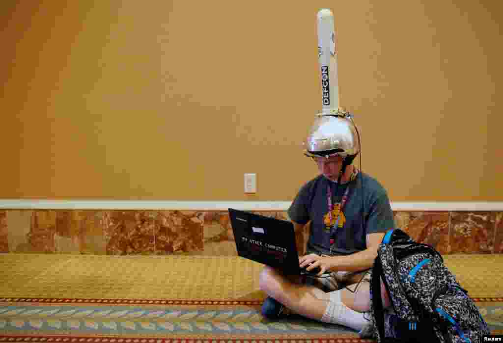 Michael Berna uses a functional antenna attached to his helmet to monitor wi-fi networks during the Def Con hacker convention in Las Vegas, Nevada, July 29, 2017.