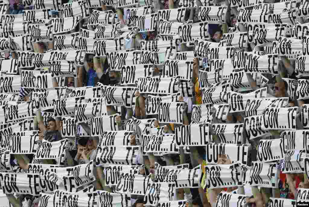 Juventus&#39; supporters hold up banners which read, &quot;With...You&quot;, referring to Juventus&#39; coach Antonio Conte, during the Italian Serie A soccer match againt Cagliari at Juventus stadium in Turin.