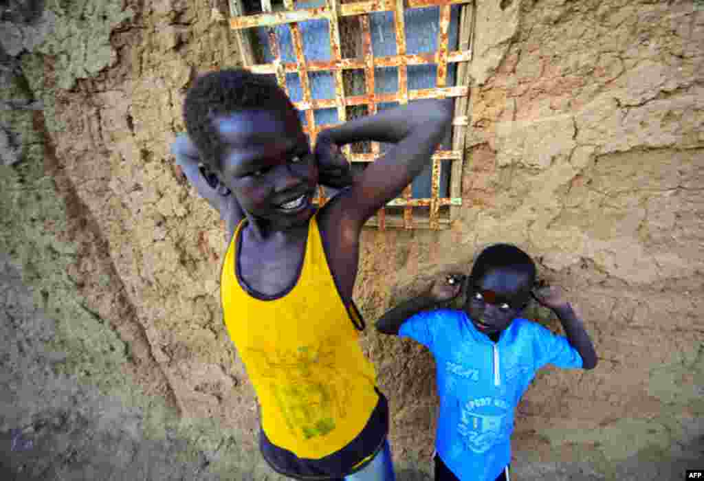 Jan. 6: Southern Sudanese boys staying in north Sudan wait at their house at the Hadj Yoasf district in Khartoum. After south Sudan votes as expected to secede from the north on Jan. 9, leaders of both countries must still resolve a daunting range of prac