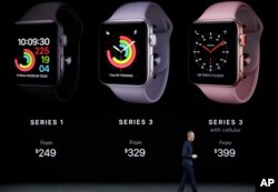 FILE - Jeff Williams, Apple's chief operating officer, shows new Apple Watch Series 3 products at the Steve Jobs Theater on the new Apple campus in Cupertino, Calif., Sept. 12, 2017.