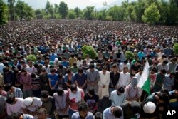 FILE - Kashmiri villagers pray during the funeral of Burhan Wani, chief of operations of Indian Kashmir's largest rebel group Hizbul Mujahideen, in Tral, 38 km south of Srinagar, Indian controlled Kashmir, July 9, 2016.
