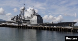 FILE - The USS Shiloh (CG-67) is docked at a port along Subic Bay, north of Manila, Philippines, May 30, 2015.